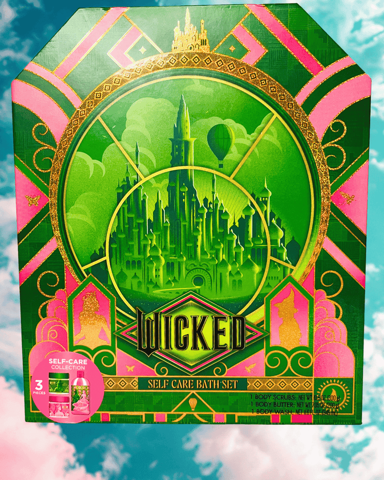 Front of Wicked three piece self-care bath set packaging with green and pink design on a blue and pink cloud background