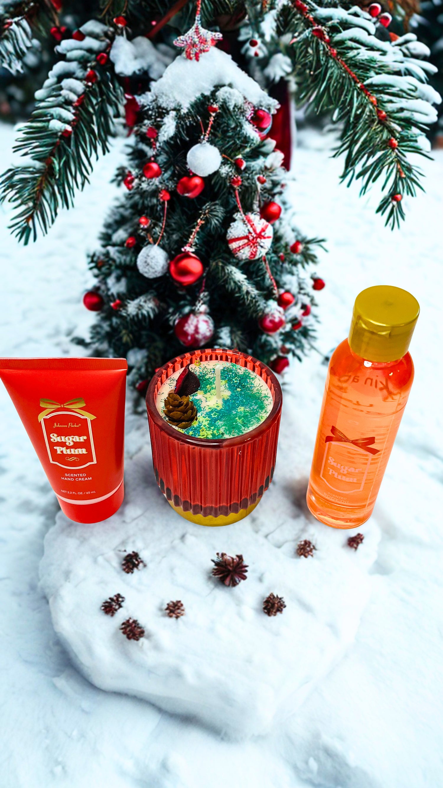 Christmas-themed candle bottle, and hand cream on a snowy background.