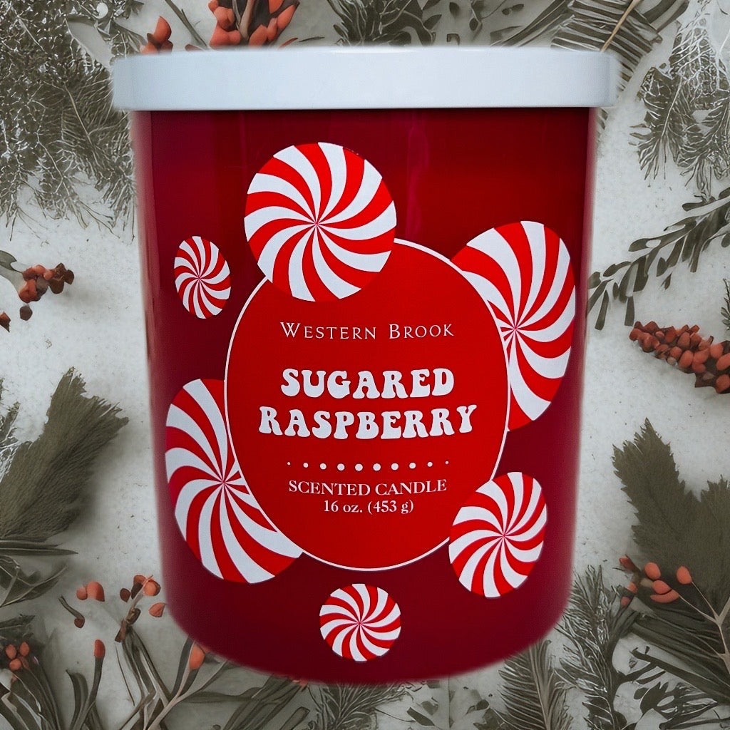 Sugared raspberry two wick candle with peppermint candy design and decorative background.