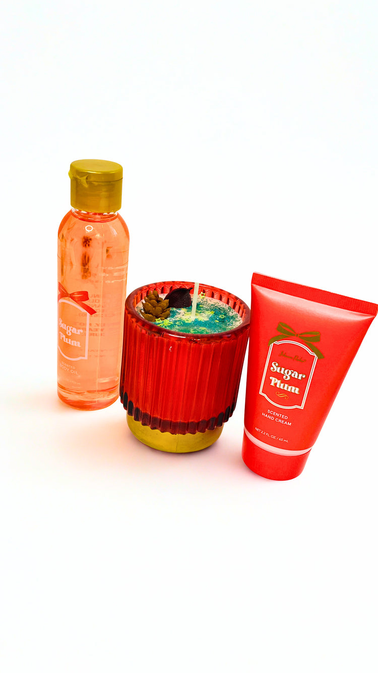 Set of skincare products including a bottle, candle, and tube on a white background