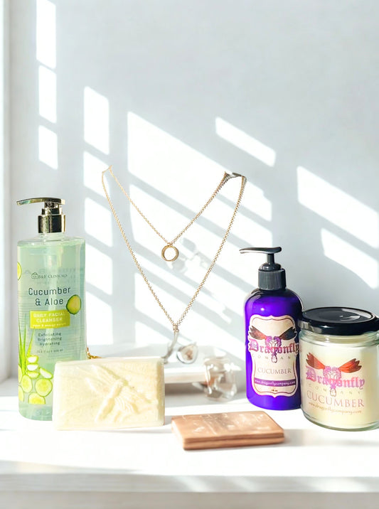Bathroom products including a lotion, soap, and candle, facial cleanser and a necklace  on a windowsill with sunlight streaming in.