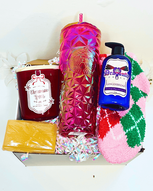 Gift set with a candle, Starbucks tumbler, gingerbread soap, and gingerbread lotion and socks in a box.