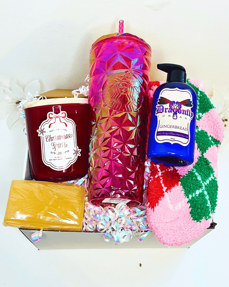 Gift set with a candle, Starbucks tumbler, gingerbread soap, and gingerbread lotion and socks in a box.