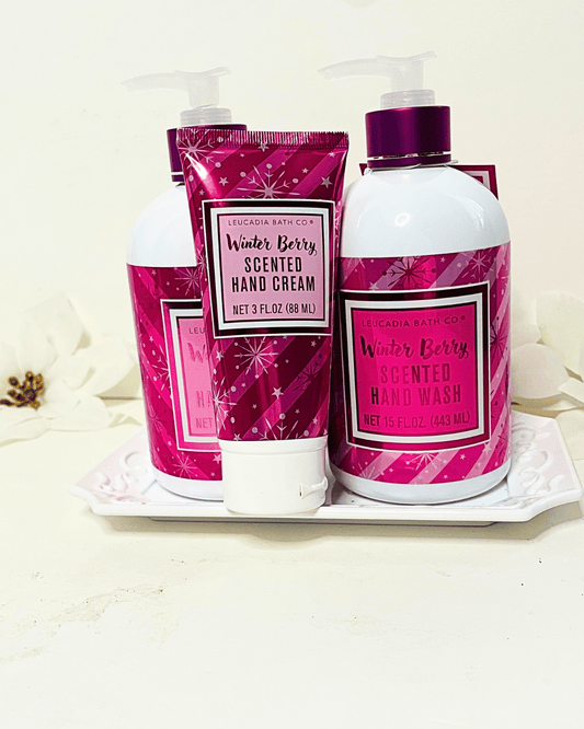 Hand cream and hand wash set with pink packaging on a white tray