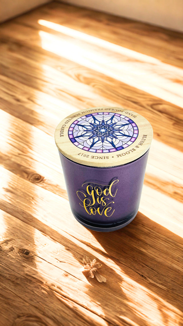 Purple candle with decorative lid on a wooden surface