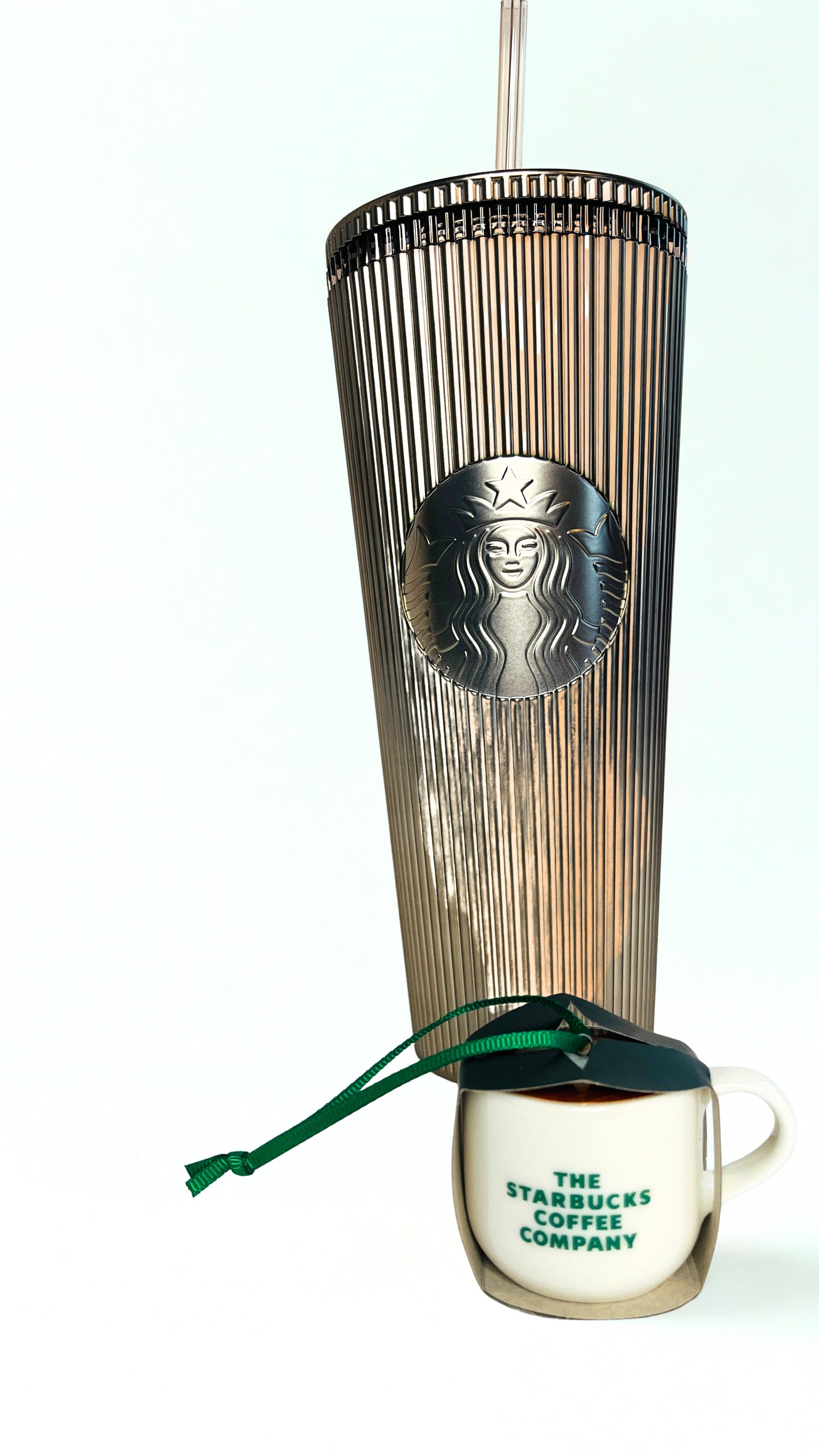 Gold Starbucks tumbler  with ornament on a white background