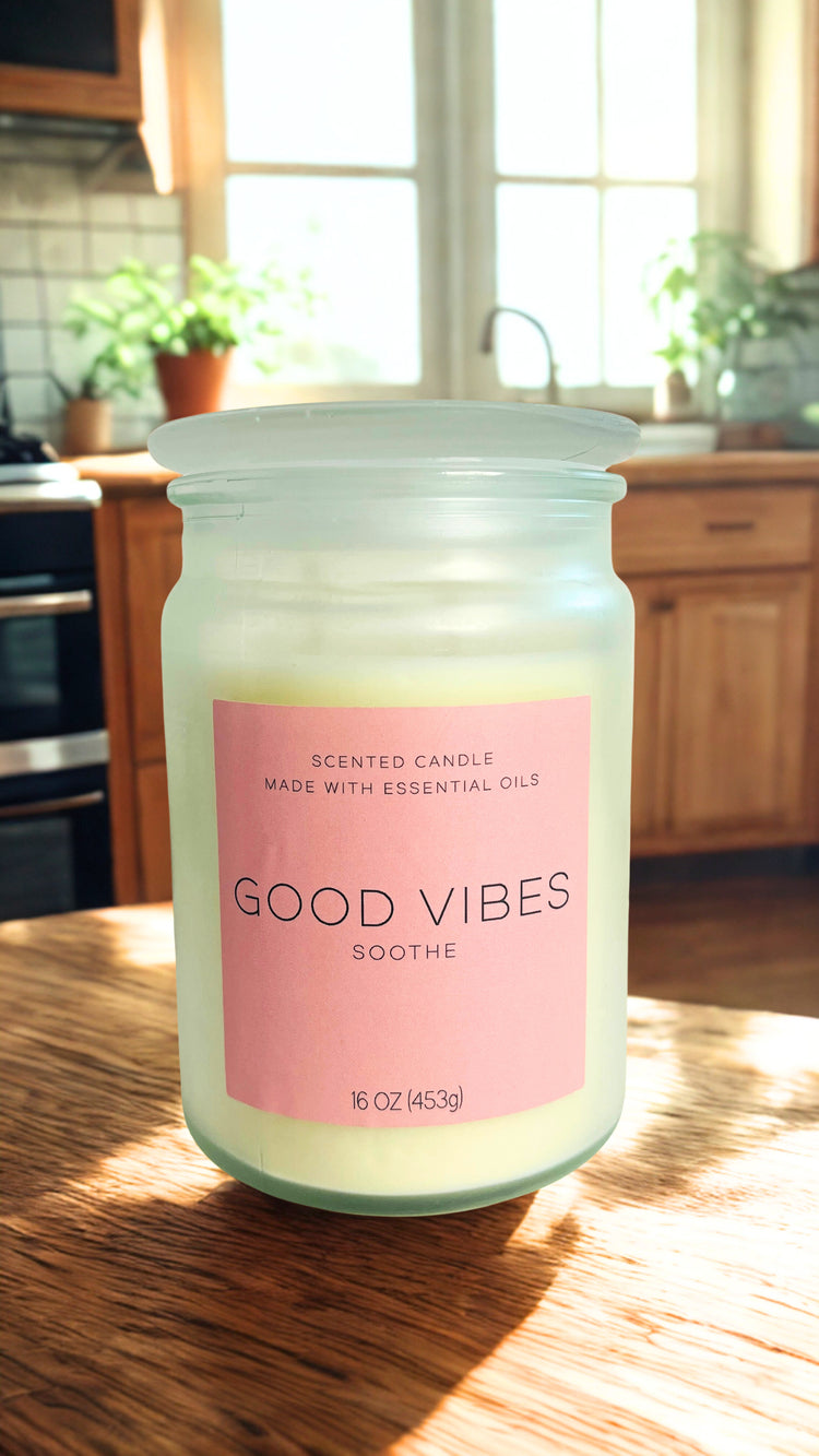 Candle labeled 'Good Vibes' on a kitchen counter with natural light