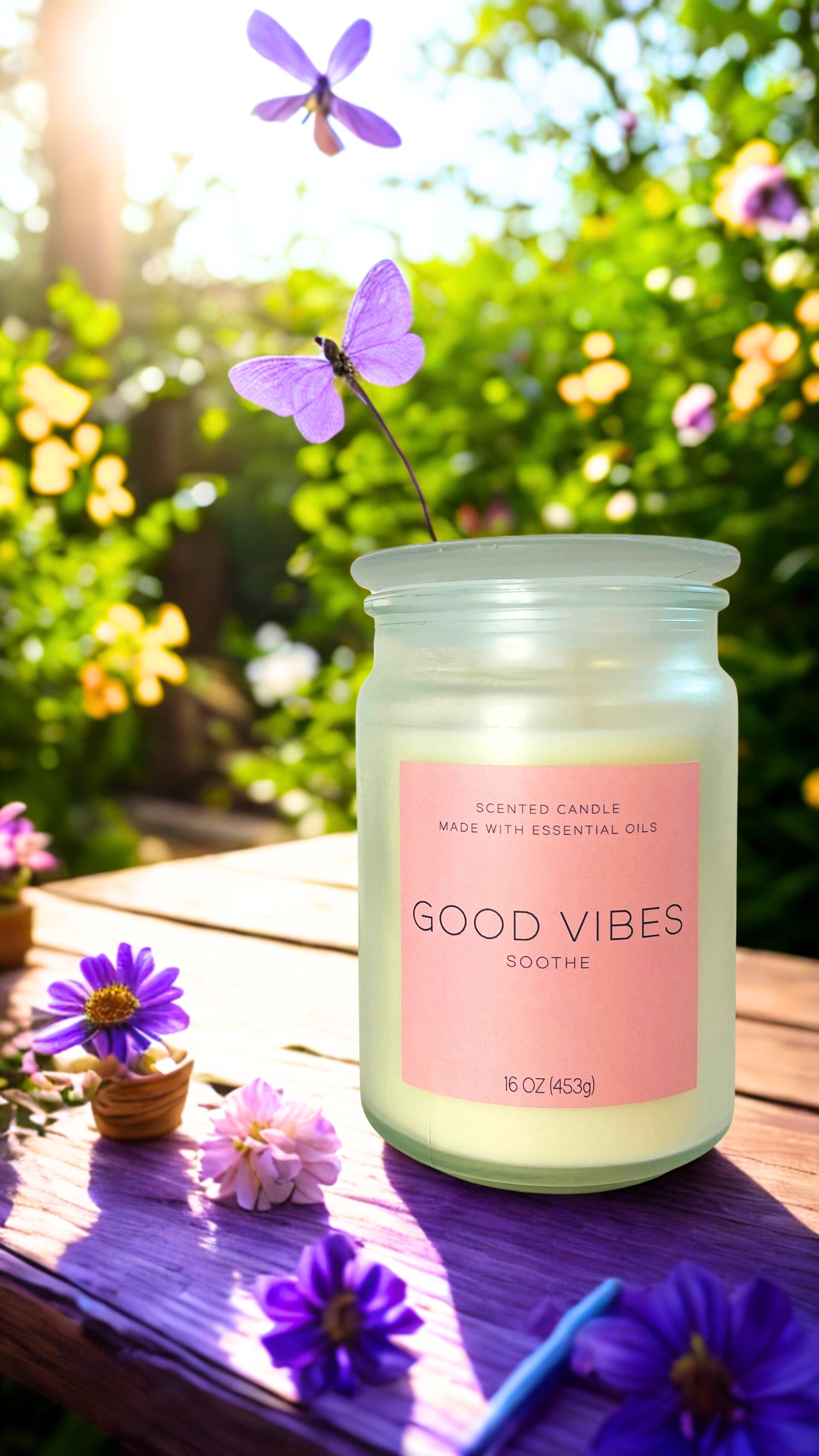 Candle jar labeled 'Good Vibes' on a wooden surface with flowers in the background